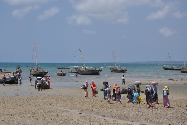 People and boats at the coast of Zanzibar